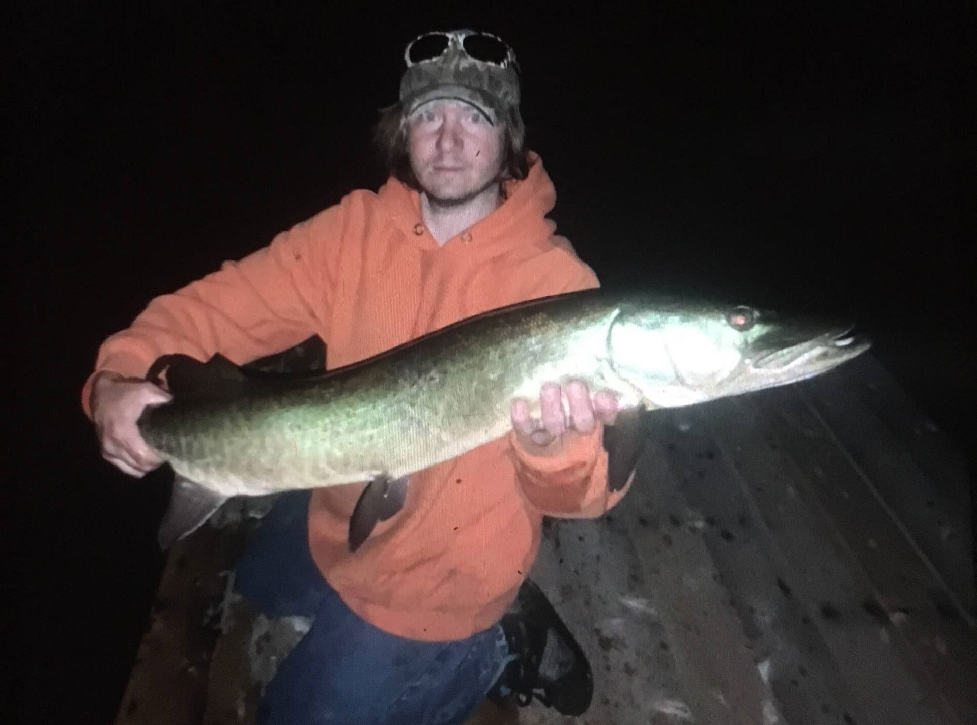 man with caught muskie fish