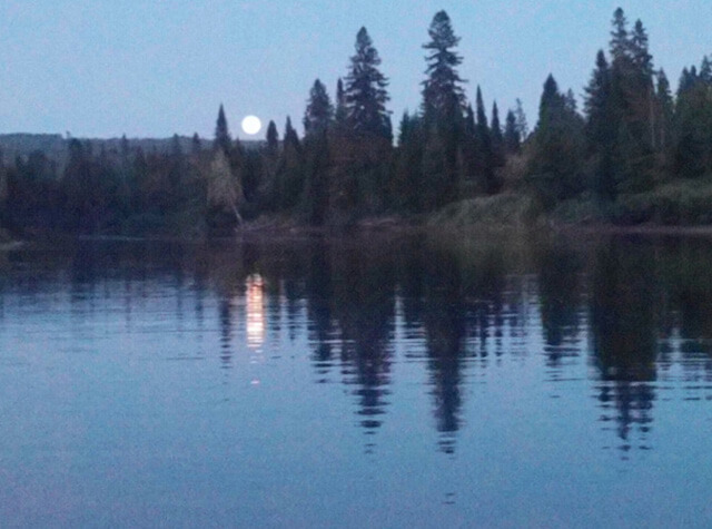 man kayaking on northern maine river